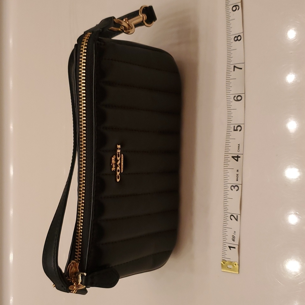 Coach Bag black with gold zipper 7.5 inches long and 4.5 inches tall.